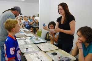 Stacey Camp discusses artifacts with a visitor